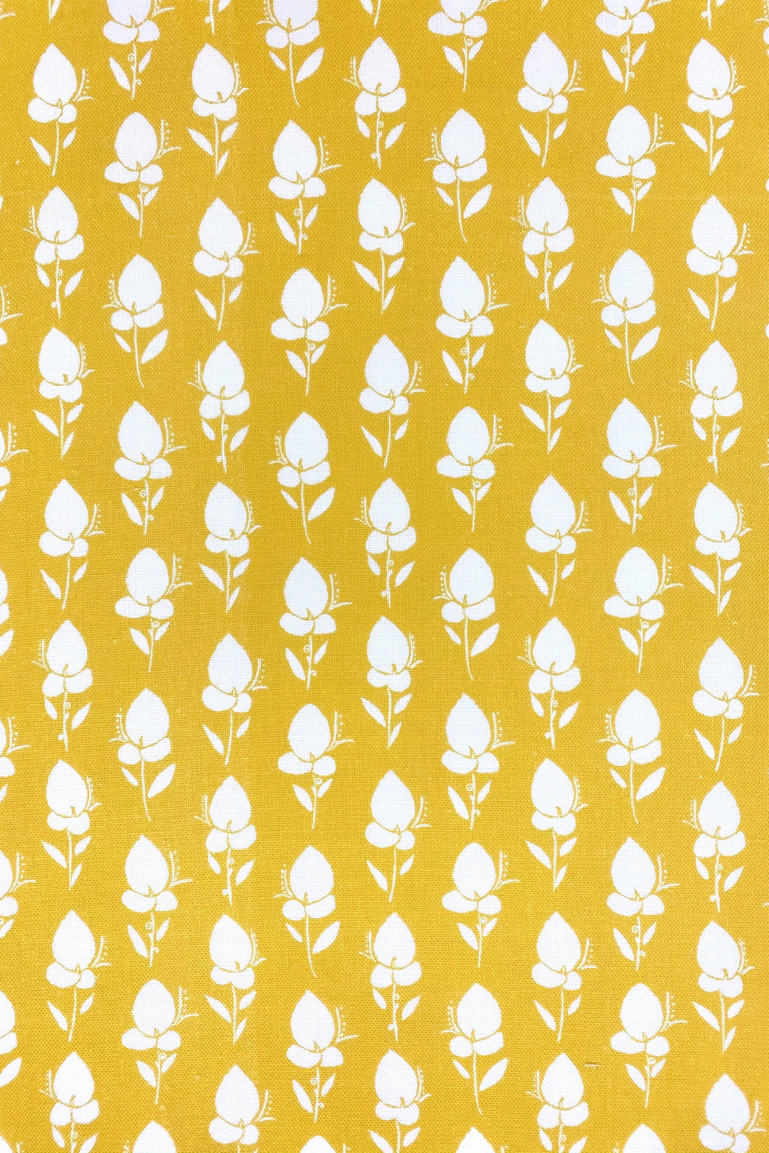 Floral fabric printed on sustainable linen for interiors in yellow color.