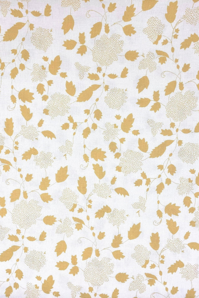 Floral fabric printed on sustainable linen for interiors in yellow color.