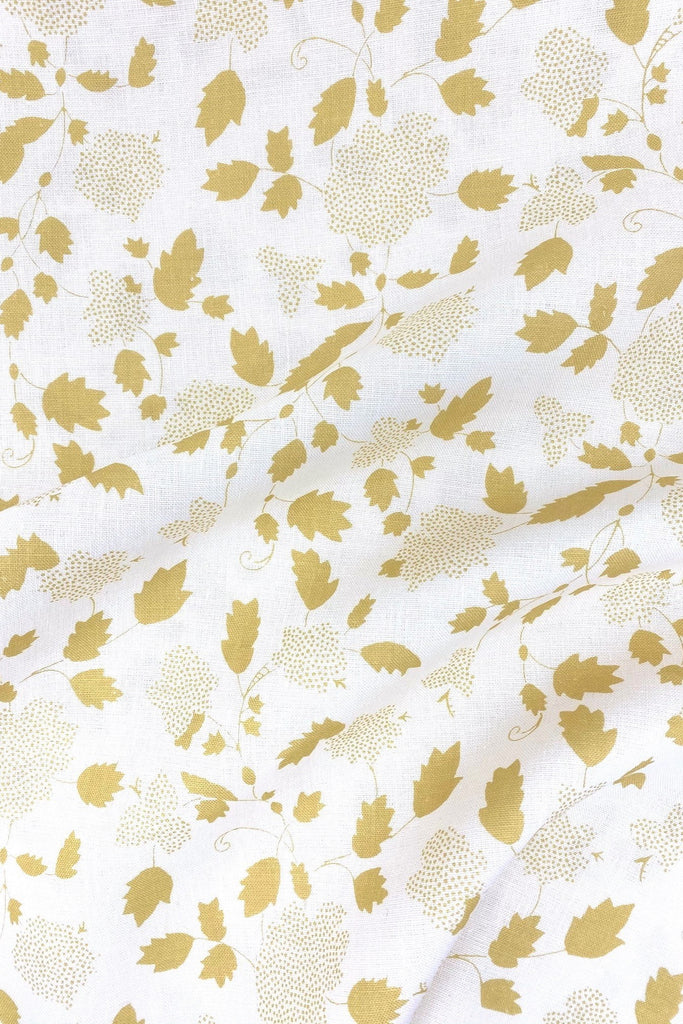 Floral fabric printed on sustainable linen for interiors in yellow color.
