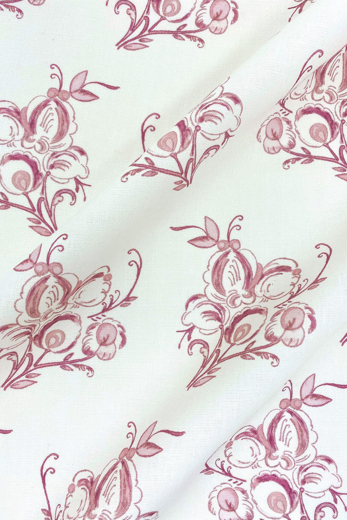 Floral fabric printed on sustainable linen for interiors in pink color.